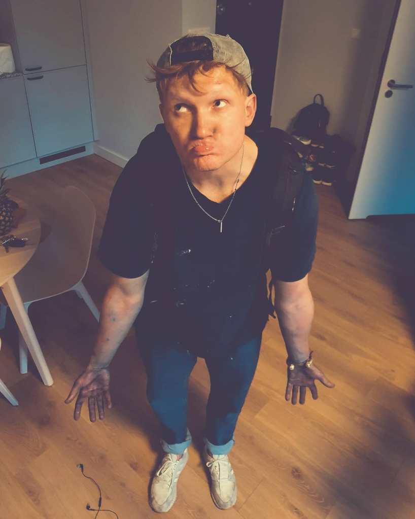 Igor Dobrowolski posing with paint on his hands