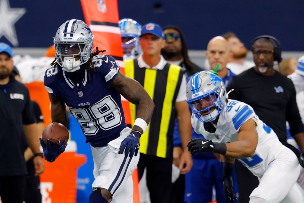 Dallas Cowboys wide receiver CeeDee Lamb (88) gains yards after catching a pass as Detroit Lions safety Brian Branch (32) pursues in the first half of an NFL football game in Arlington, Texas, Sunday, Oct. 13, 2024.  