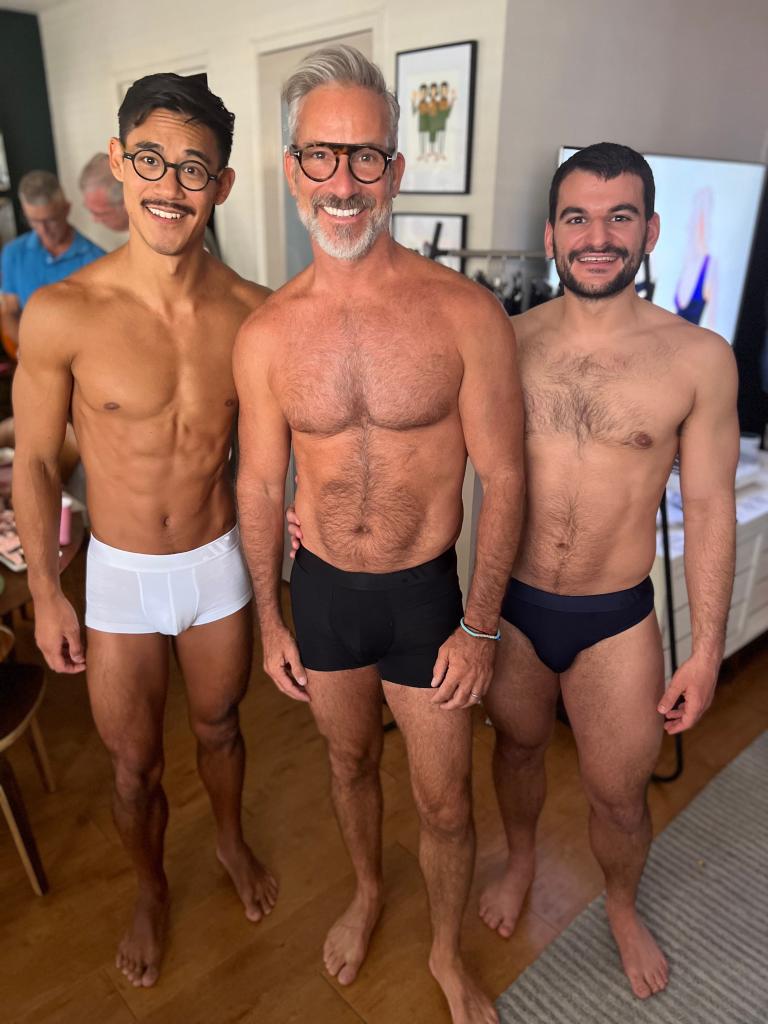 Garrett Swann standing in the middle of a group of three men, all wearing ALPHX underwear, with Kenji Johjima detected in the image