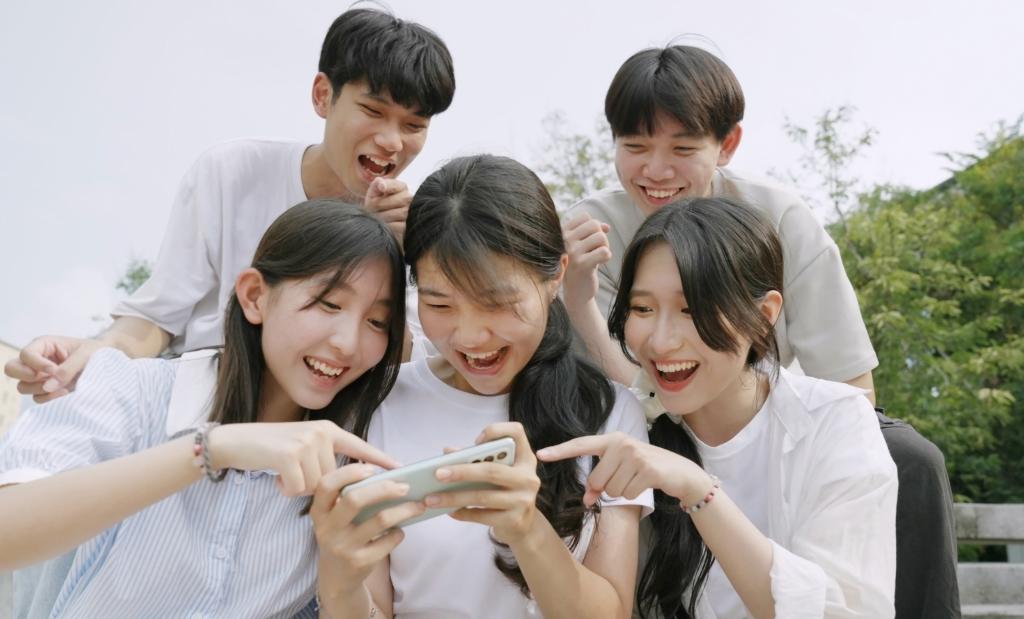 Chinese kids looking at their phone