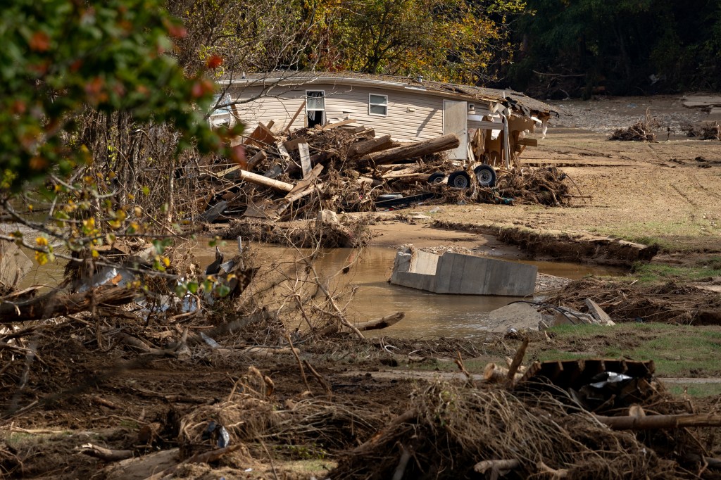 Damaged homes and roads in Bat Cave after the region was hit by Helene.