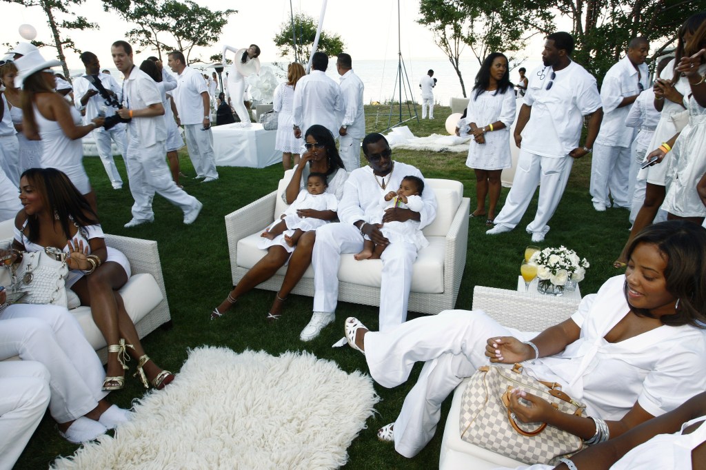 Sean "Diddy" Combs and Kim Porter with their twin daughters at his White Party in 2007.