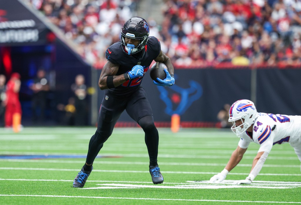 Texans wide receiver Nico Collins (12) runs with the ball after a reception