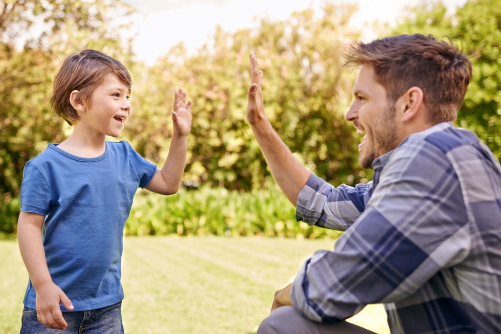  Cropped shot of a young father giving his son a high-five.