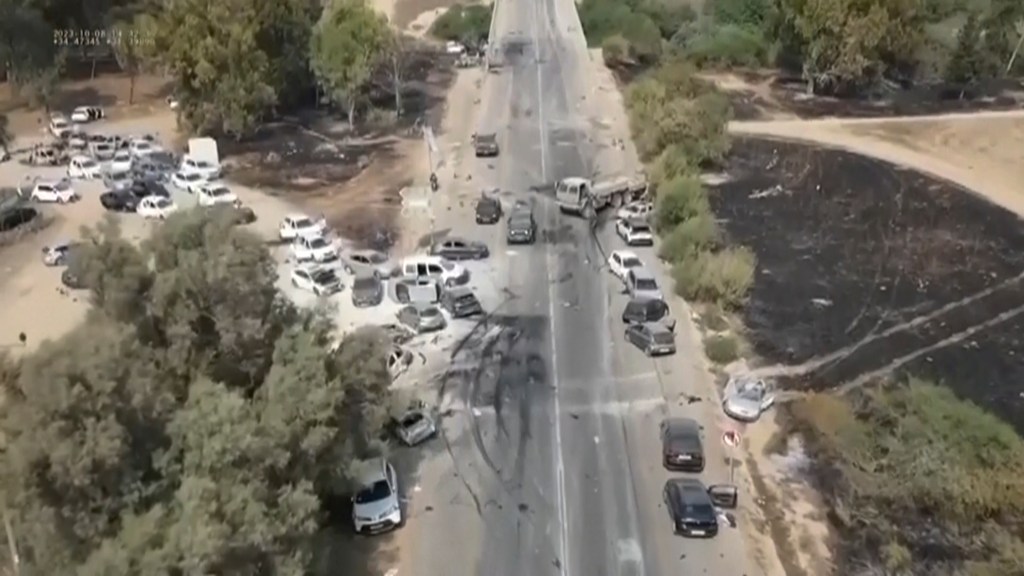 Charred and damaged cars along a desert road after an attack by Hamas militants at the Tribe of Nova Trance music festival near Kibbutz Re'im in southern Israel on Saturday, Oct. 7, 2023. 