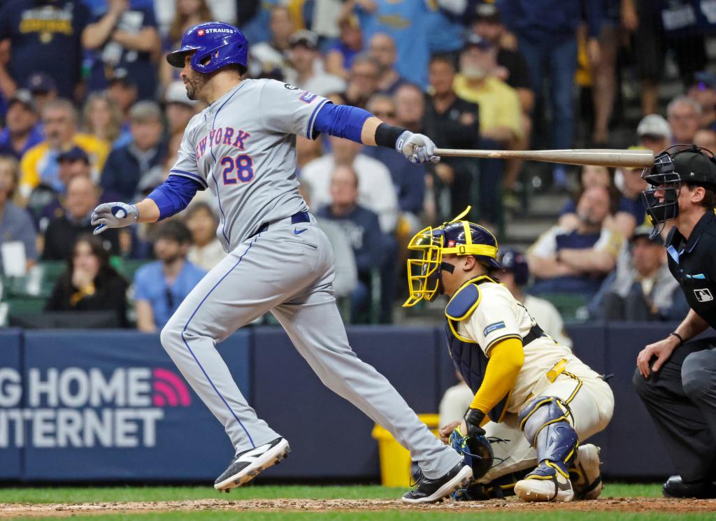 J.D. Martinez #28 of the New York Mets hitting a two-run RBI single during a baseball game against the Milwaukee Brewers at American Family Field.