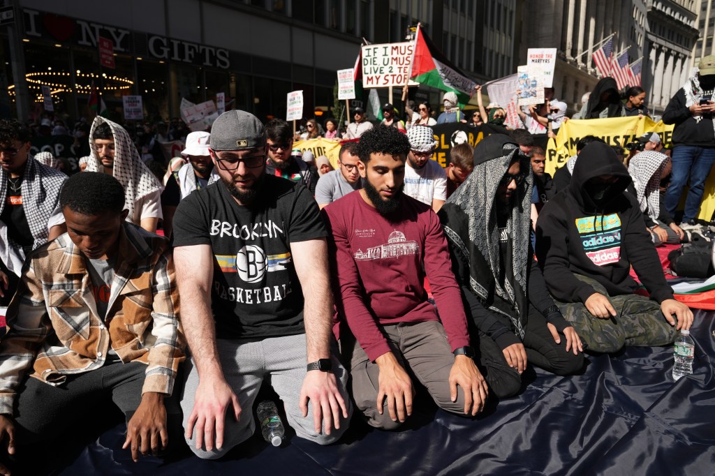 Pro-Palestinian demonstrators pray near Wall Street.