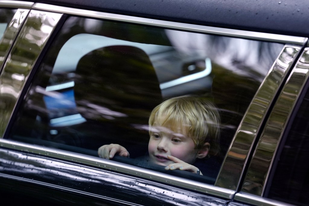 James Kennedy, great grandson of Ethel Kennedy, seated in a vehicle participating in Ethel Kennedy's funeral procession, departing Our Lady of Victory church