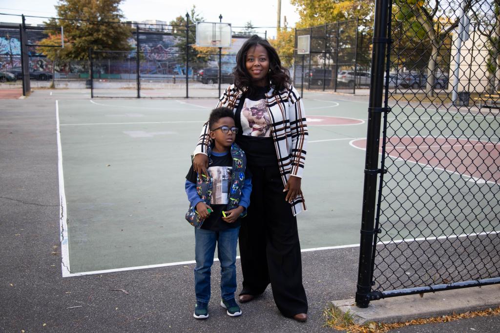 The cop's daughter stands with her 8-year-old son at the park named for her dad.