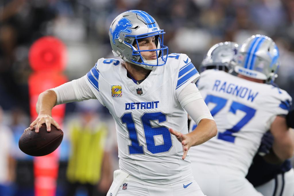 Jared Goff #16 of the Detroit Lions throws a pass in the third quarter of a game against the Dallas Cowboys at AT&T Stadium on October 13, 2024 in Arlington, Texas.