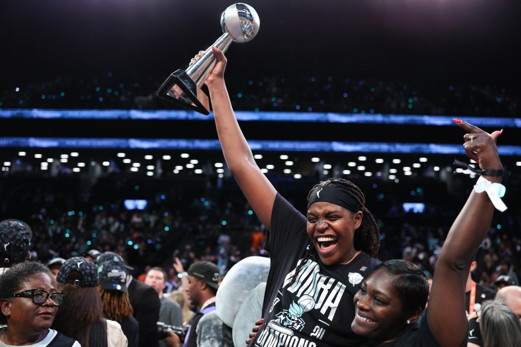 Jonquel Jones celebrates with the WNBA Championship trophy after the Liberty's win over the Lynx on Oct. 20, 2024. 