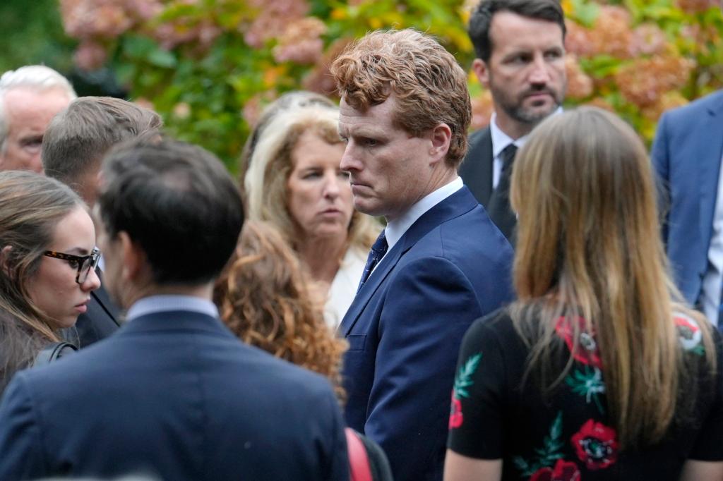 Joseph Kennedy III in a suit outside the funeral.