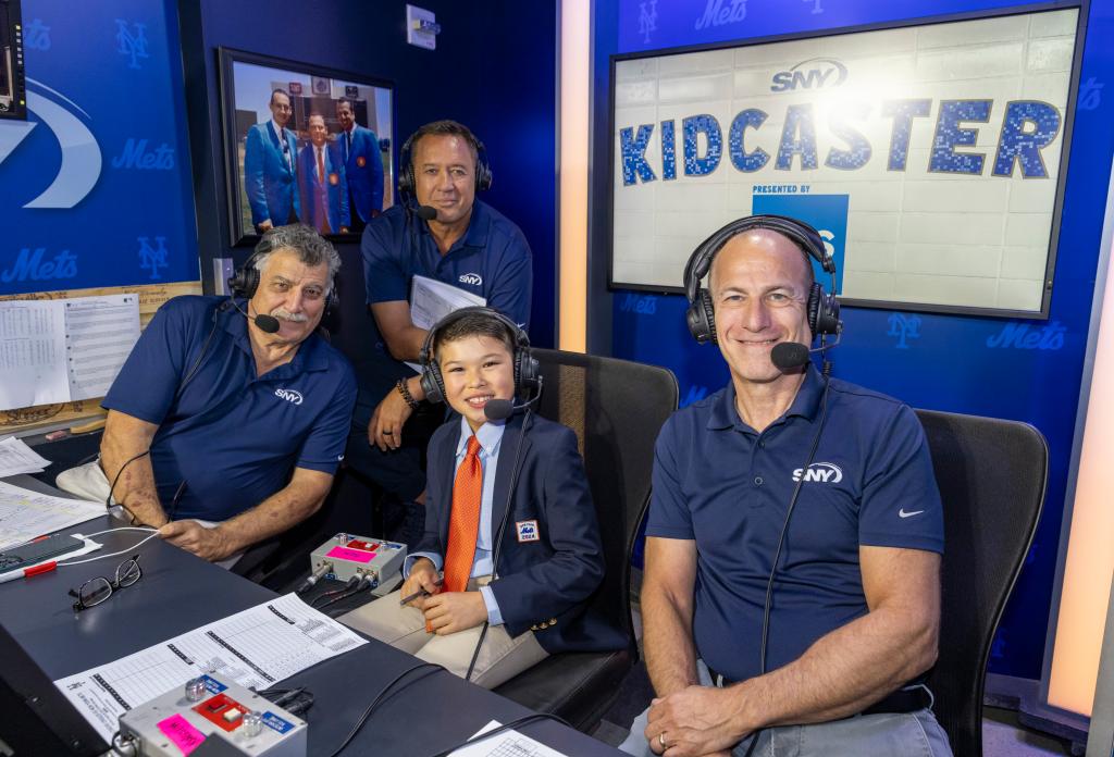 9-year-old Kingston Korn, winner of Kidcaster, posing with sports commentators Keith Hernandez, Ron Darling, and Gary Cohen at a Baltimore Orioles vs. New York Mets game at Citi Field