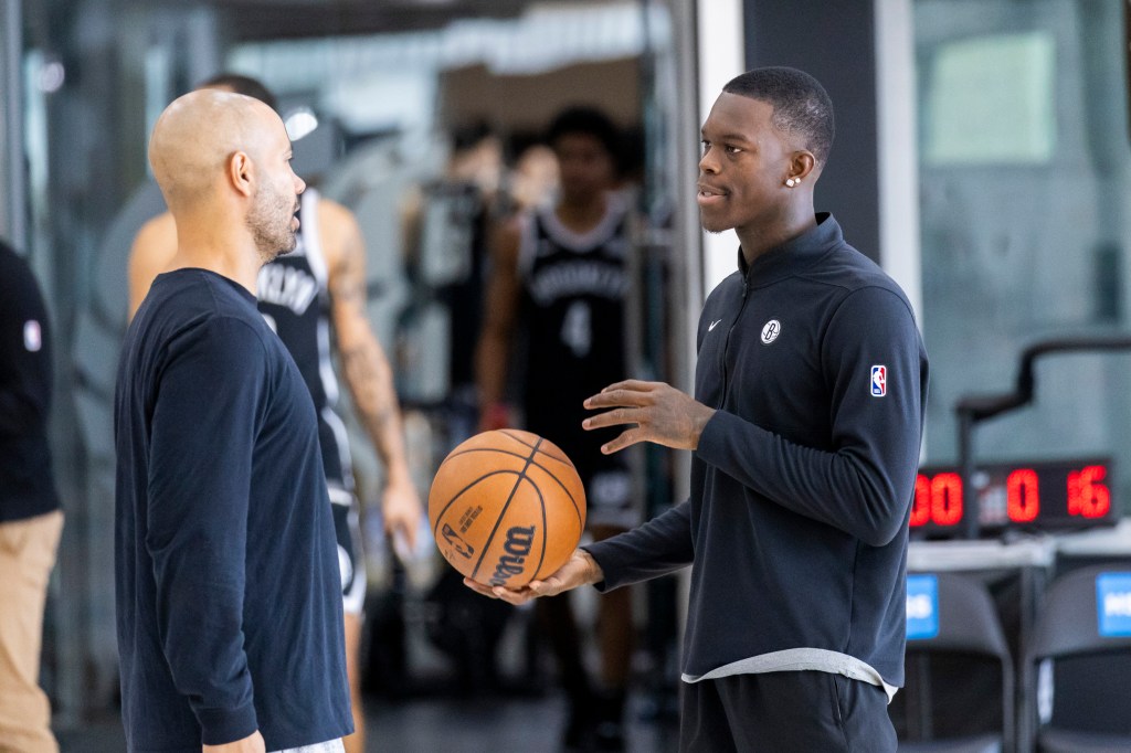 Nets head coach Jordi Fernandez (l.) speaks with guard Dennis Schroder during Media Day