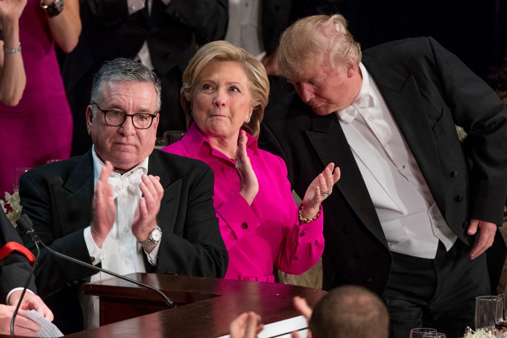 Alfred E. Smith IV, Hillary Clinton, and Donald Trump standing and applauding at the 71st annual Alfred E. Smith Memorial Foundation Dinner, New York, 2016