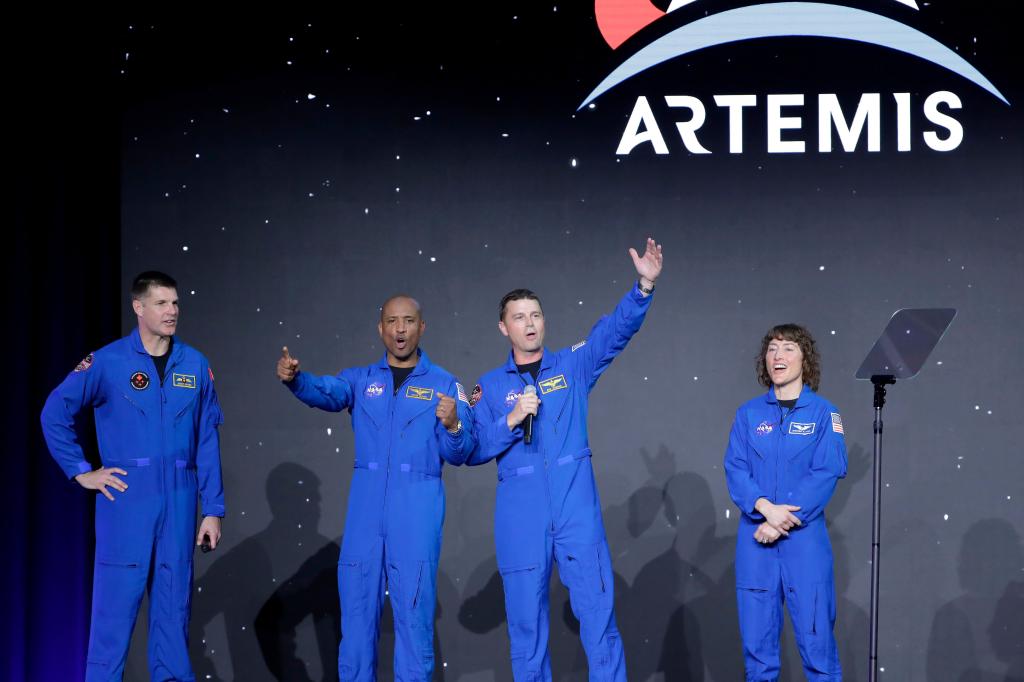 Astronauts Jeremy Hansen, Victor Glover, Reid Wiseman and Christina Hammock Koch celebrating on stage during the Artemis II crew announcement at a NASA ceremony