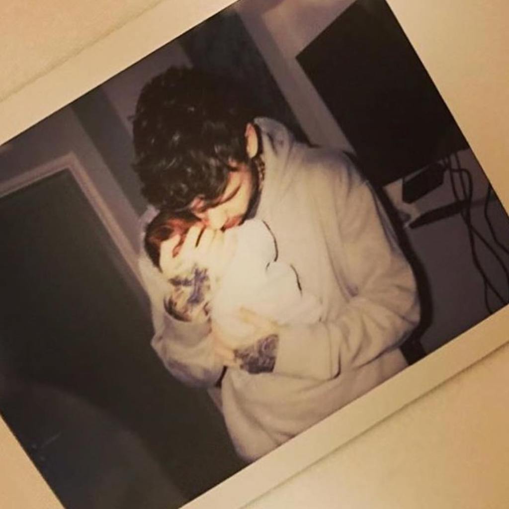 Liam Payne holds newborn son, Bear.