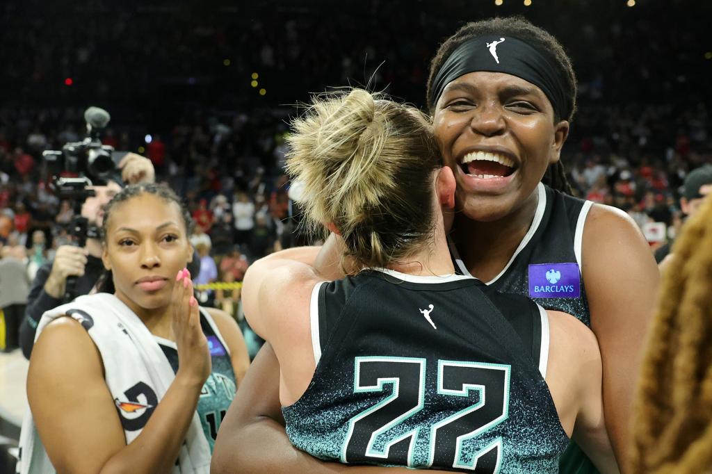 Jonquel Jones and Courtney Vandersloot (22) embrace following the Liberty's Game 4 win.