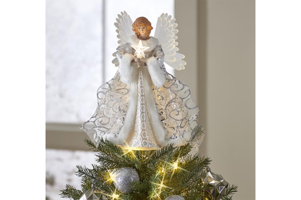 A white angel Christmas tree topper with a star