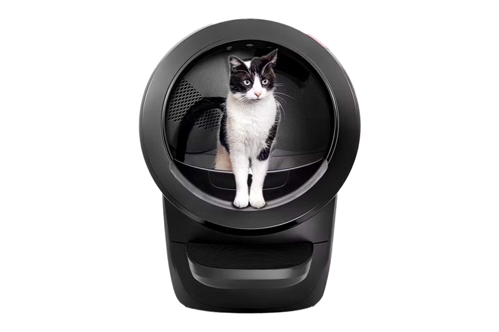 A cat sitting in a device named 'LitterRobot'