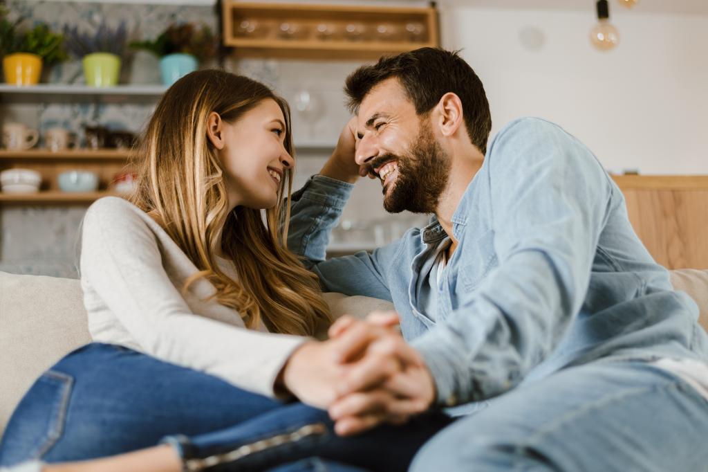 Loving happy couple talking to each other at home