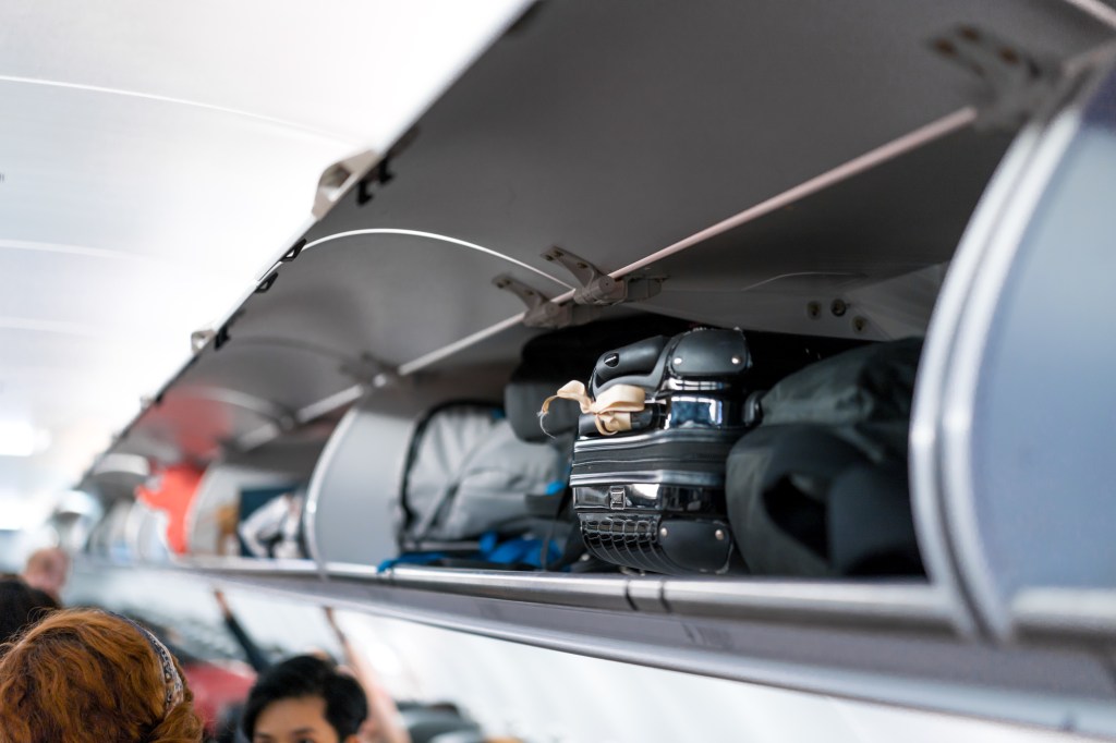 A file photo of a bag in an overhead airplane compartment.