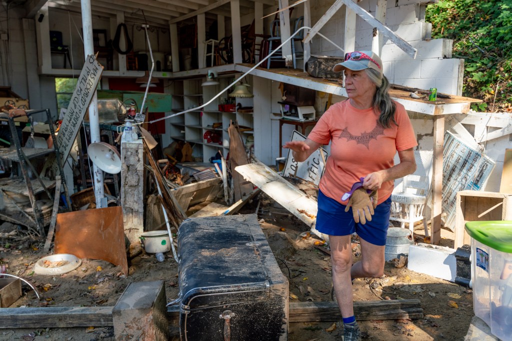 Lynn Staton inside her destroyed antique shop in Bat Cave.