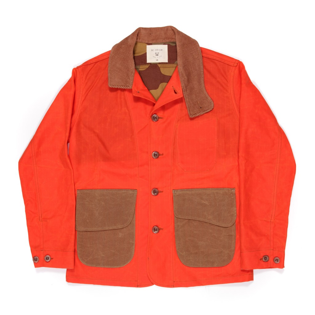 Orange M Crow waxed barn jacket with brown patches, available for $750