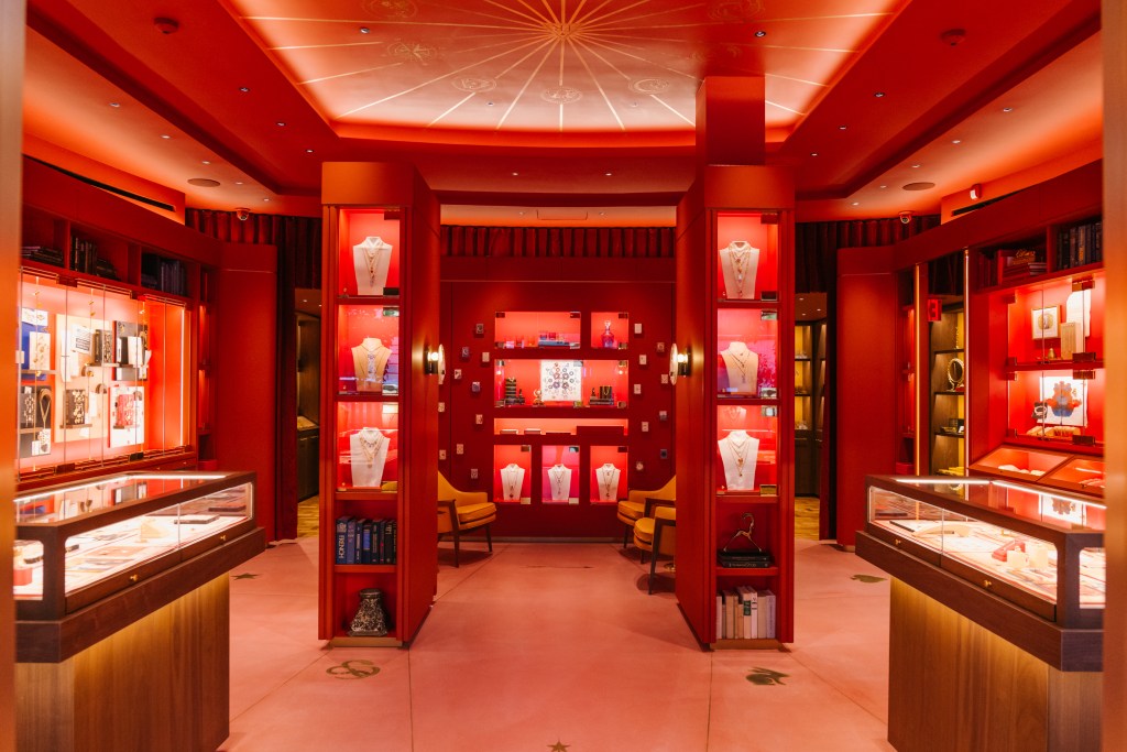 A room with red walls and shelves displaying jewelry on Madison Avenue