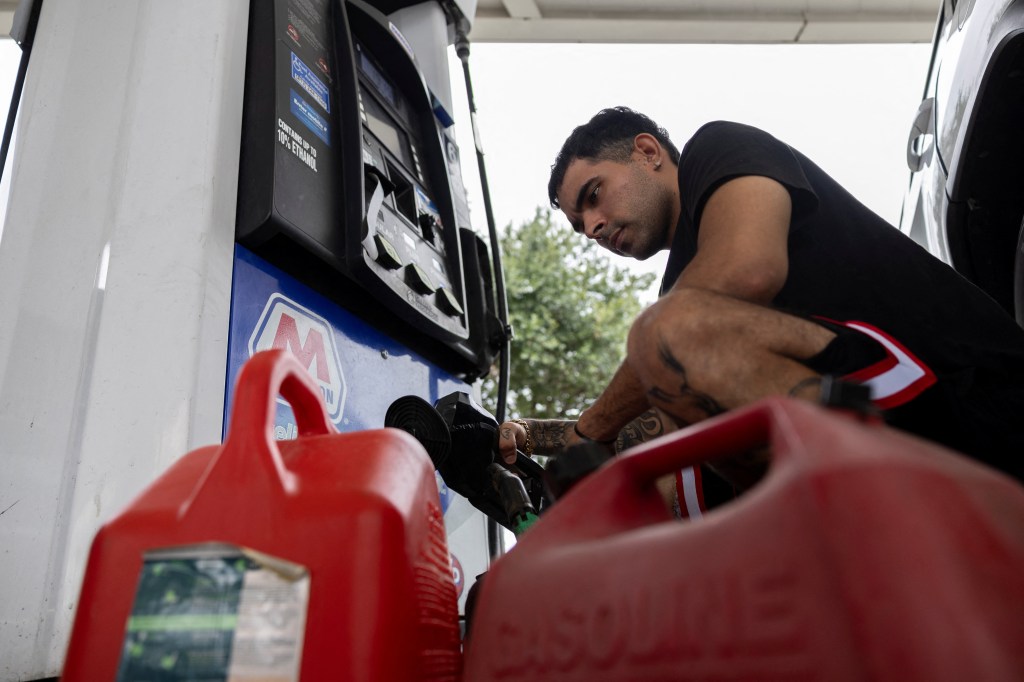 A man filling up gas containers at a station in Tampa ahead of Milton's arrival on Oct. 8, 2024.