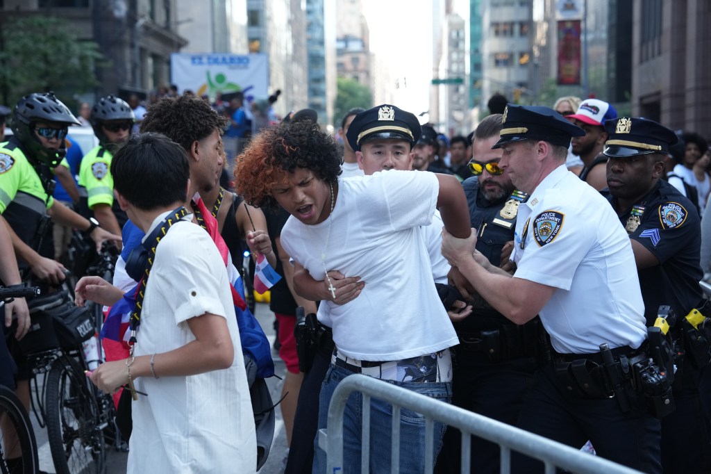 Cops arrest a man during the Dominican Day Parade. 