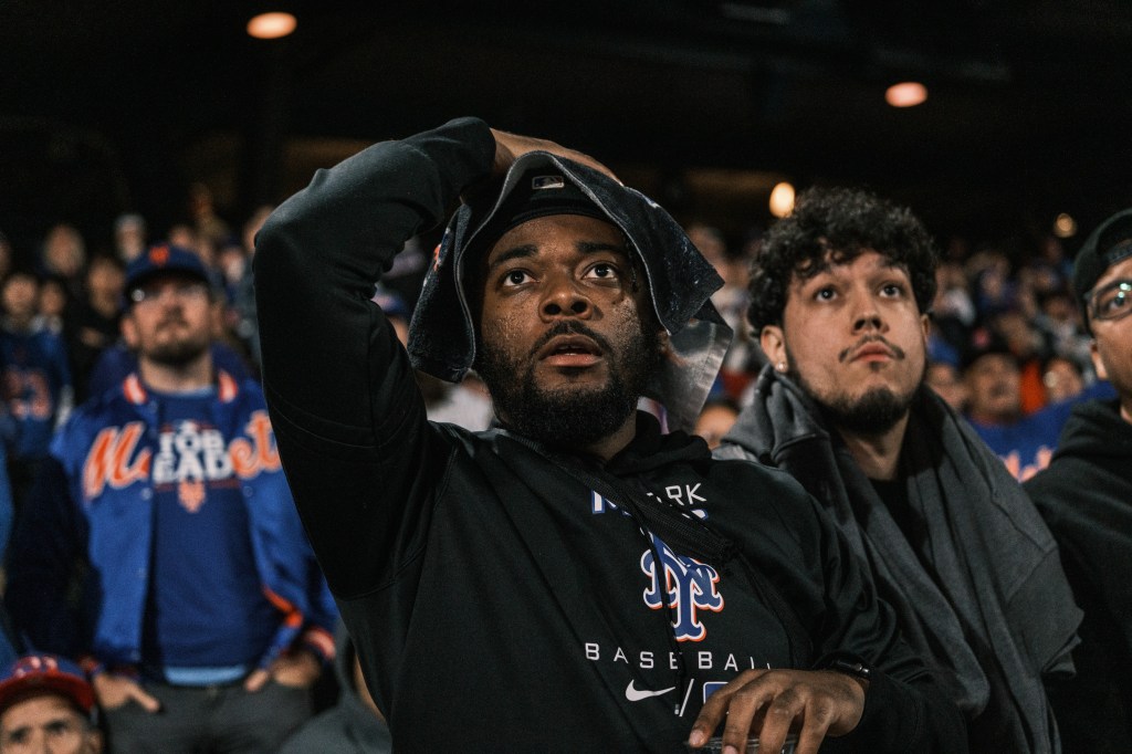 A Mets' fan looks at the video board in despair during the watch party.