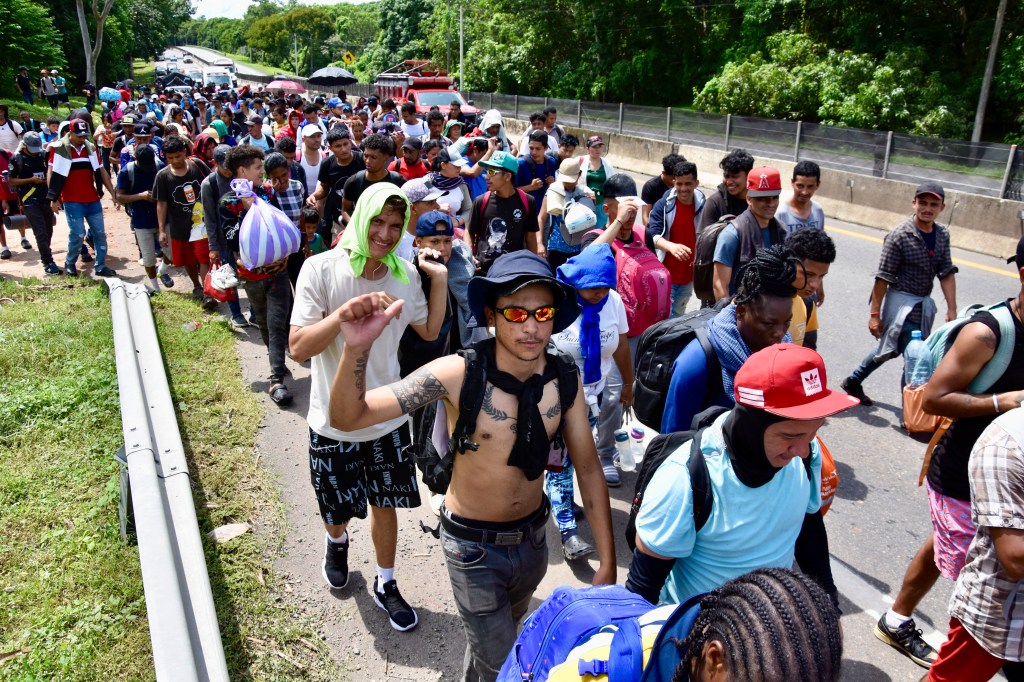 Migrants of different nationalities walk towards the United States on a highway in Tapachula, Chiapas State, Mexico