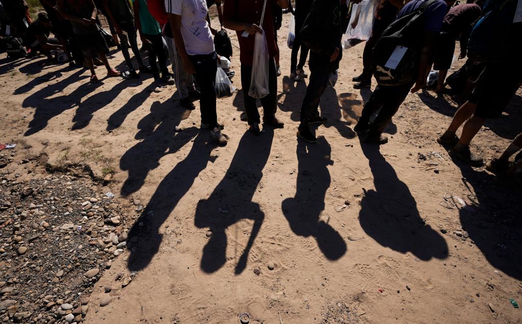 Migrants wait to be processed by the U.S. Customs and Border Patrol after they crossed the Rio Grande and entered the U.S. from Mexico, on Oct. 19, 2023, in Eagle Pass, Texas.