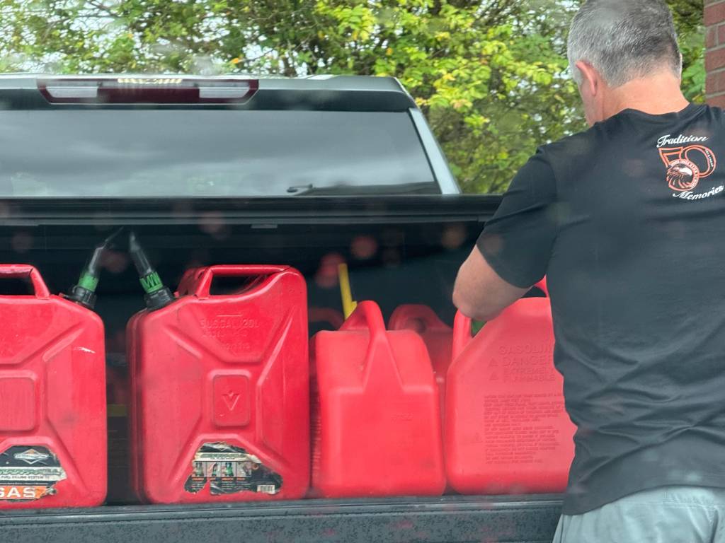  fills gas cans after refueling his vehicle at the members-only BJ's Wholesale Club gas station on Dunlawton Avenue in Port Orange