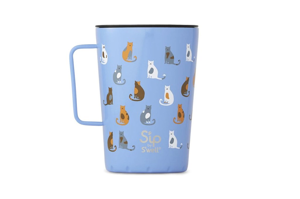 A blue mug with cat designs on it