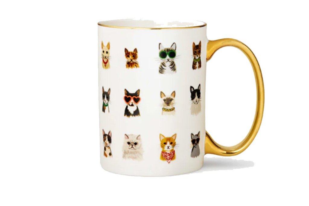 A coffee mug with a design of cats on it