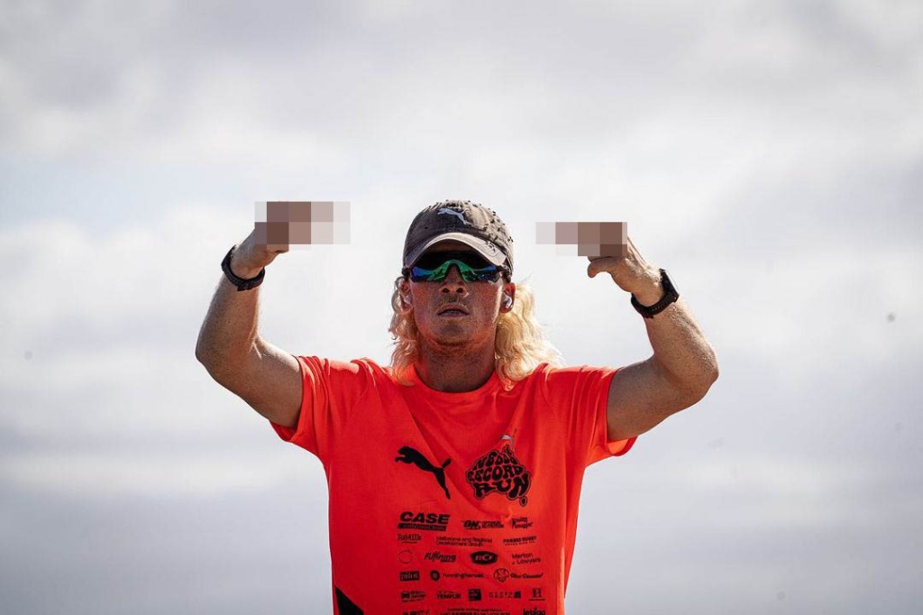 Man with long hair, wearing a hat and sunglasses, posing aggressively like Thomas Voeckler