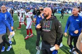 New York Giants head coach Brian Daboll on the field after a game against the Seattle Seahawks, with crowd in the background