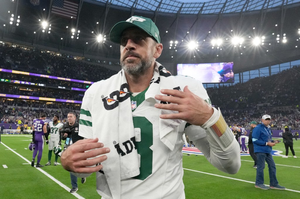 Aaron Rodgers, New York Jets quarterback, walking off the field in disappointment at Tottenham Hotspur Stadium after throwing three interceptions against the Minnesota Vikings.