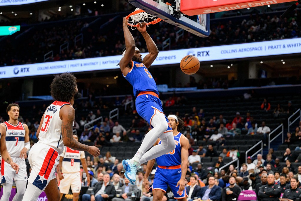 Knicks forward Precious Achiuwa (5) dunks against the Wizards on Oct. 18, 2024.