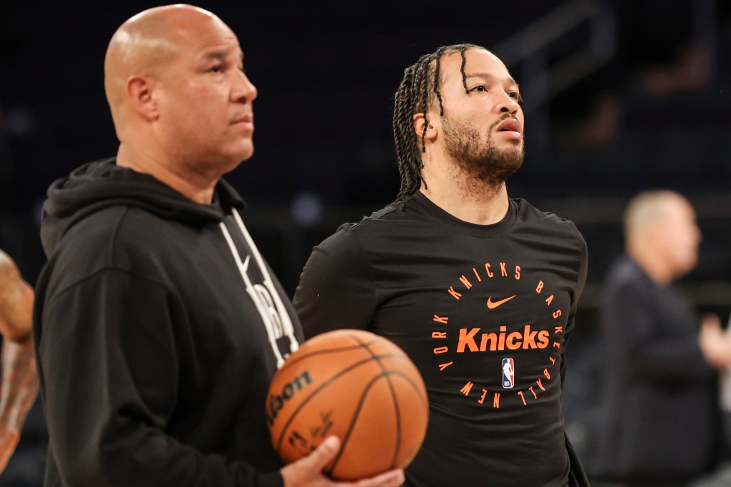 New York Knicks guard Jalen Brunson, right, stands with his father, Knicks assistant coach Rick Brunson, left, before a preseason NBA basketball game against the Minnesota Timberwolves, Sunday, Oct. 13, 2024, in New York. 