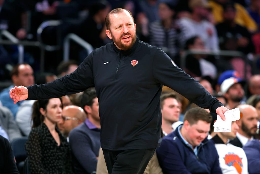 New York Knicks head coach, Tom Thibodeau, reacting during a preseason basketball game with arms spread out