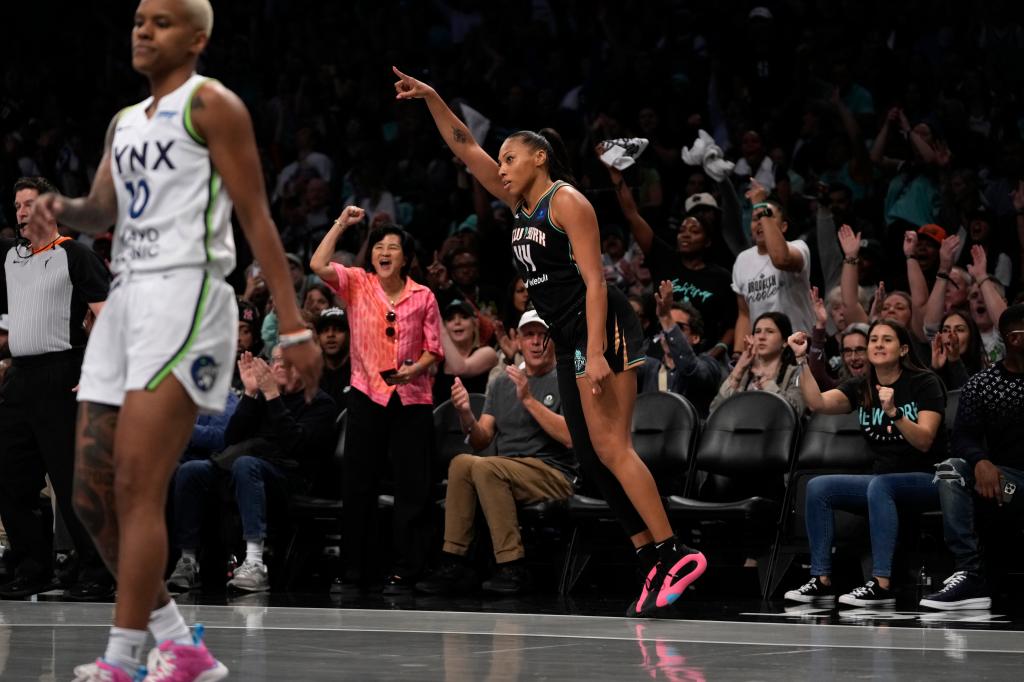 New York Liberty's Betnijah Laney-Hamilton, front right, reacts after shooting a 3-point basket during the first half in Game 2 of a WNBA basketball final playoff series against the Minnesota Lynx, Sunday, Oct. 13, 2024, in New York