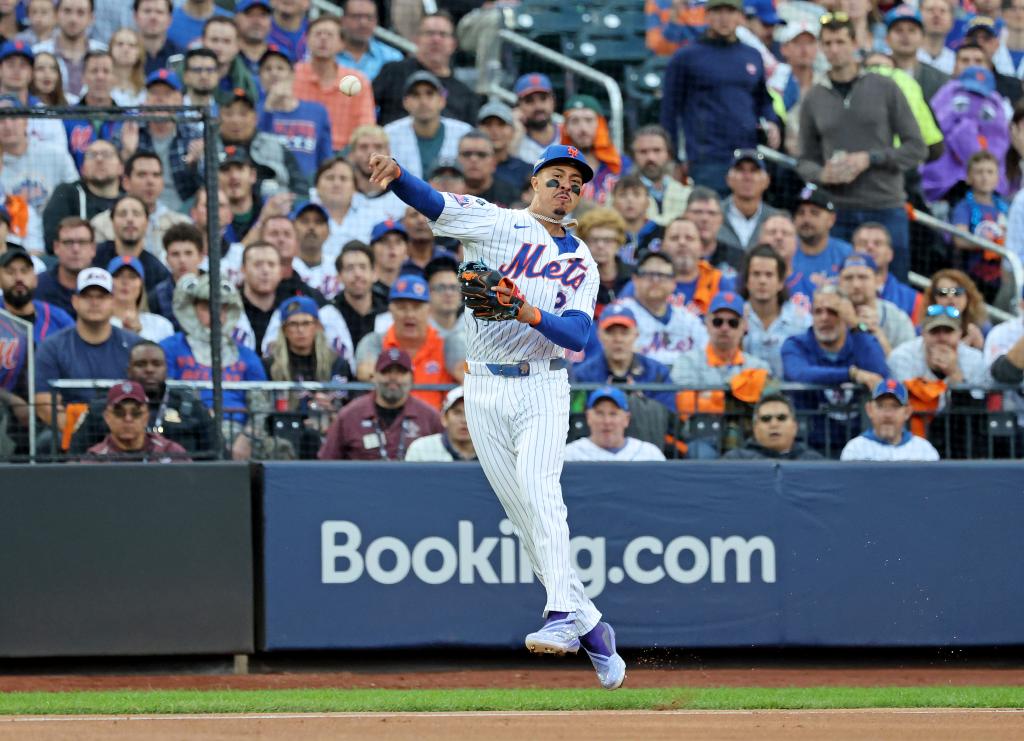 New York Mets third baseman Mark Vientos #27 throwing out Philadelphia Phillies third basemen Alec Bohm #28 during a game at Citi Field