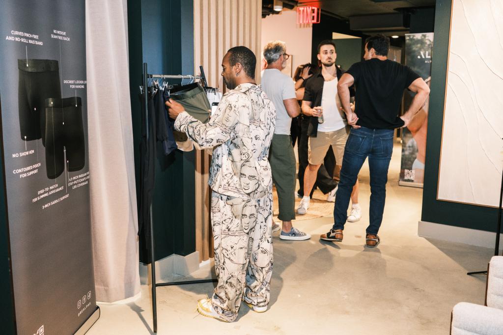 Man examining ALPHX underwear at a 'Tupperware party' event in New York, NY on September 26, 2024