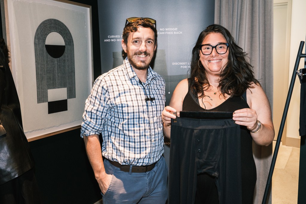 Men and women at an ALPHX underwear brand Tupperware party in New York, trying on and buying items while models showcase the underwear.