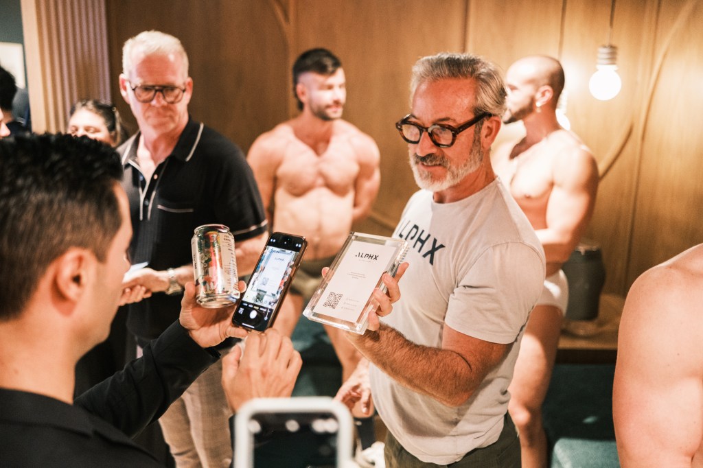 Group of men at a ALPHX Tupperware party in New York, trying on and purchasing underwear, with models also wearing the items