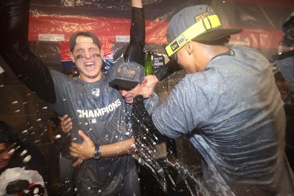 Anthony Rizzo #48, celebrates with champagne in the locker-room after the Yankees beat Cleveland to advance to the World Series