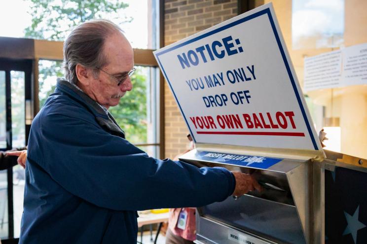 A voter dropping off a mail-in ballot at Doylestown, Pennsylvania on Oct. 15, 2024.